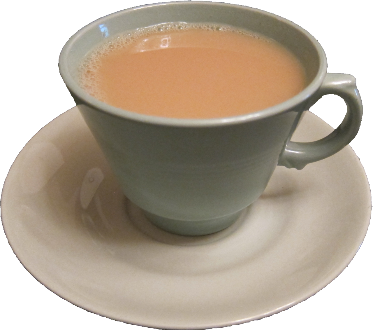 Milk tea in a muted green cup with a right-facing handle on a cream saucer.