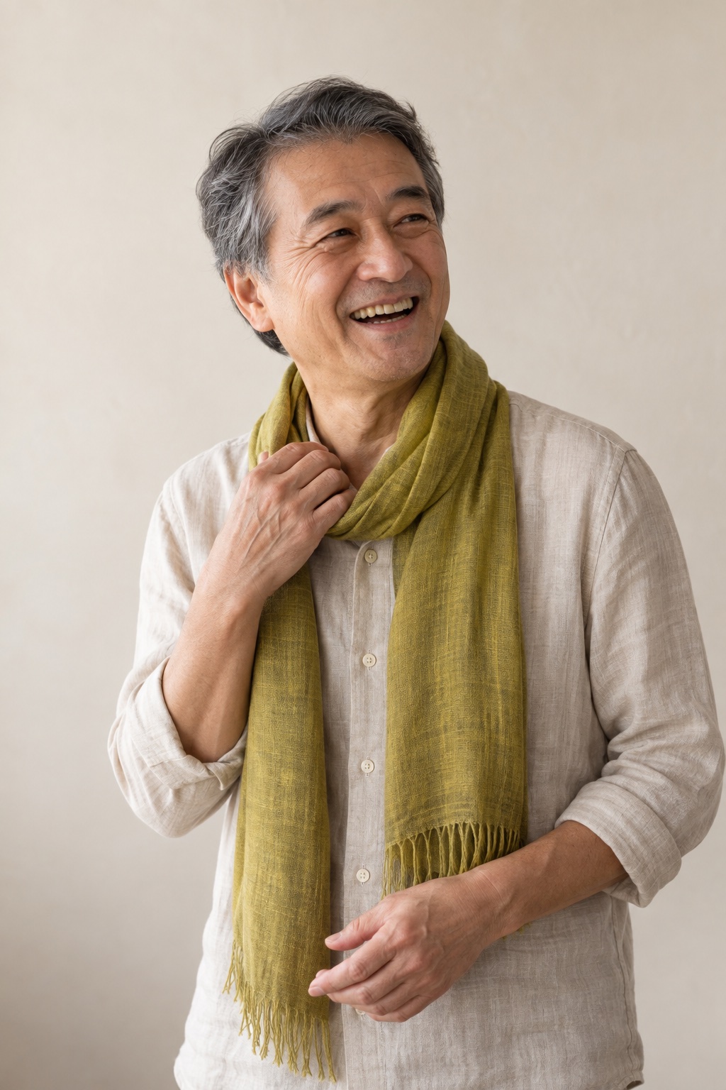 Jonah, a fictional older man with grey hair, laughing, one hand at his collar, a citron scarf around his neck.